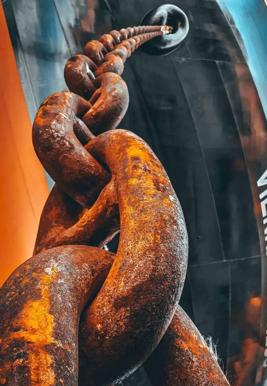 Heavy marine anchor chain and vessel hull